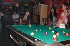 Girls playing pool in a Batam bar